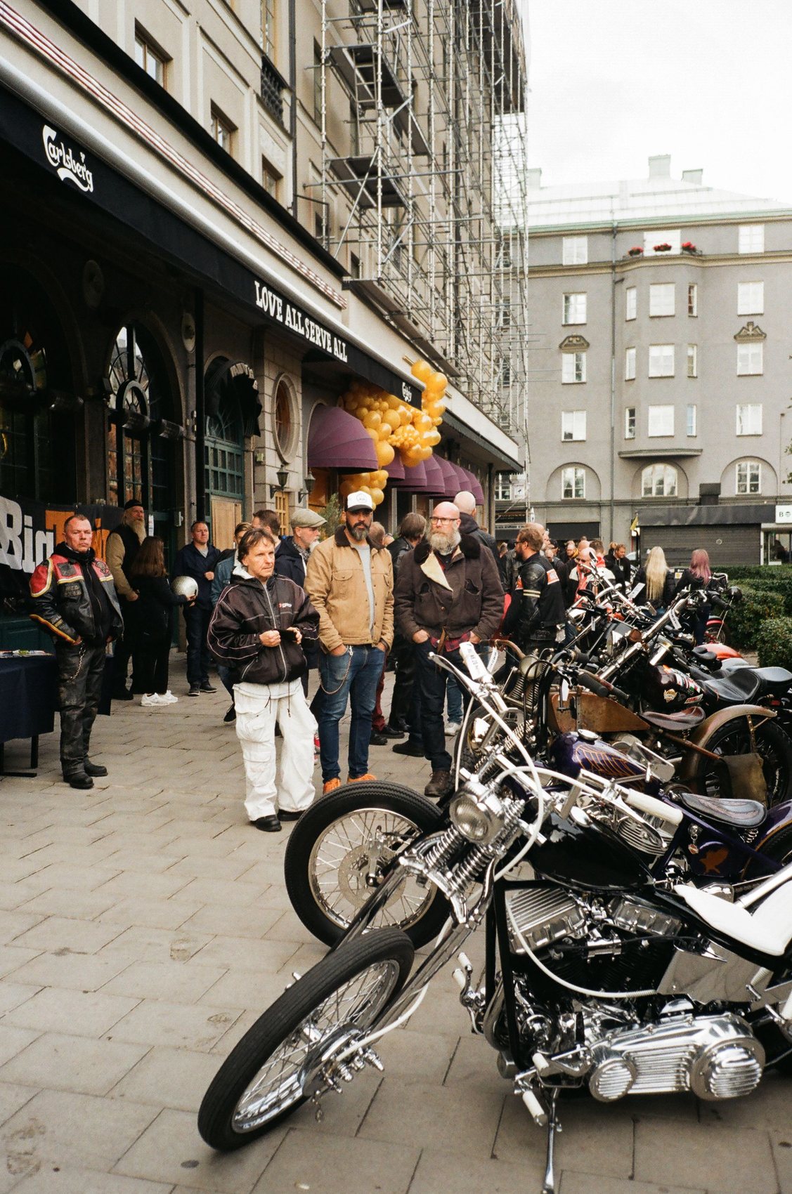 Riders and custom bikes gathered outside a venue