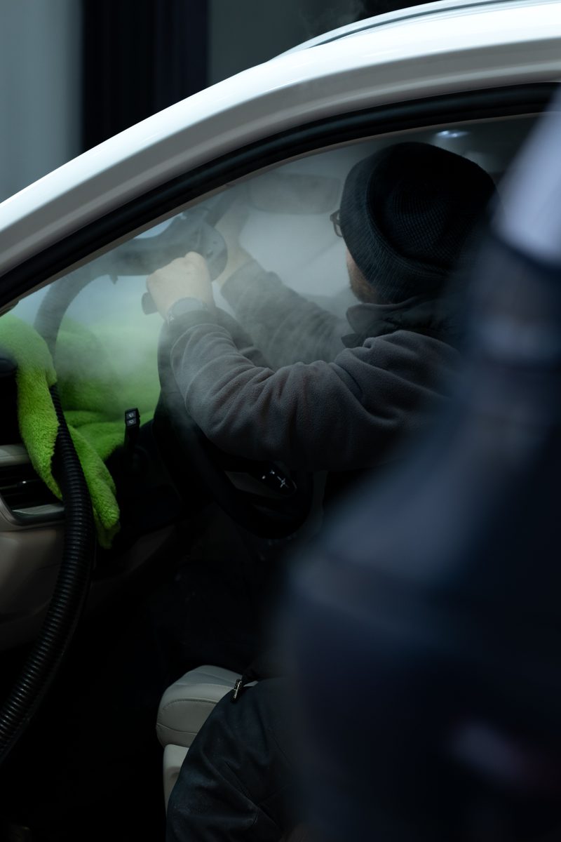 Detailer ozone-steaming a car interior